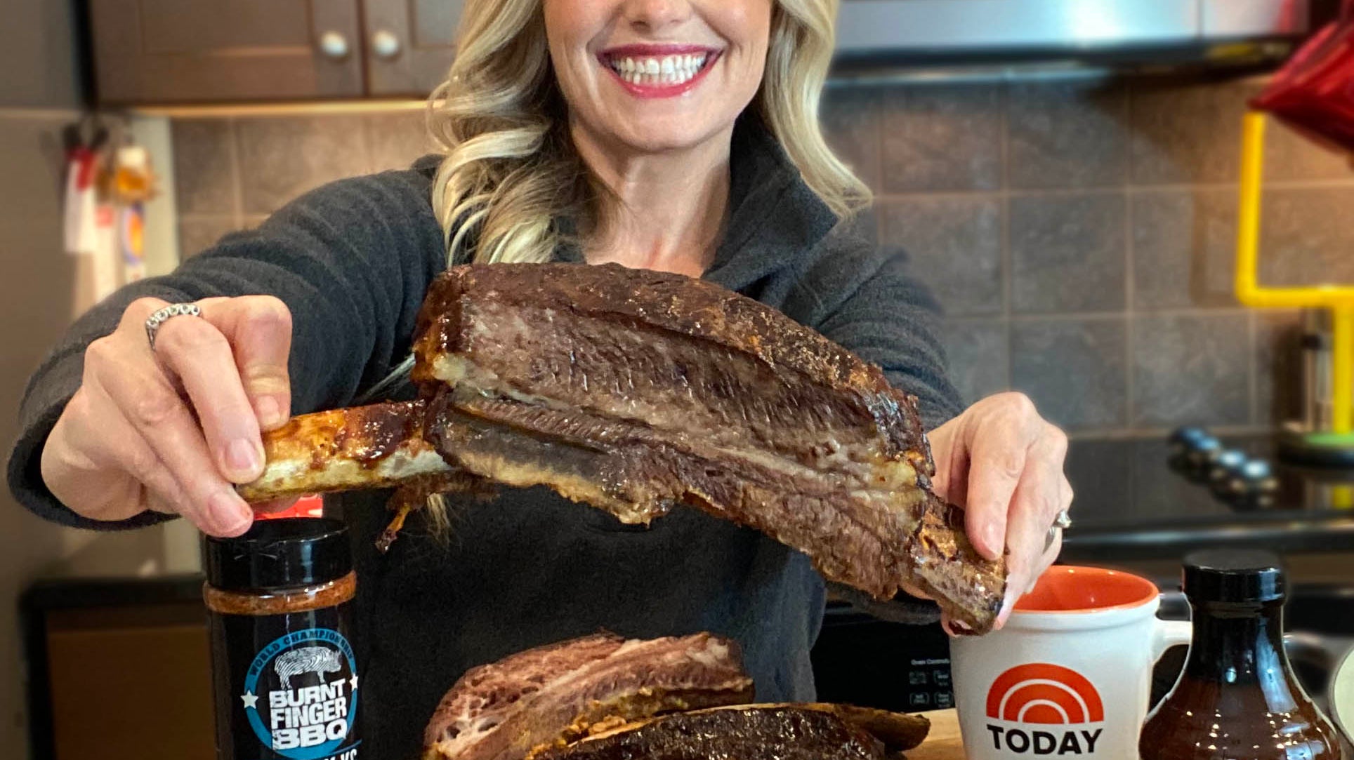 Pitmaster Megan Day holding a beef rib