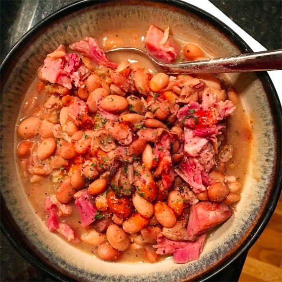 A bowl full of ham and bean soup