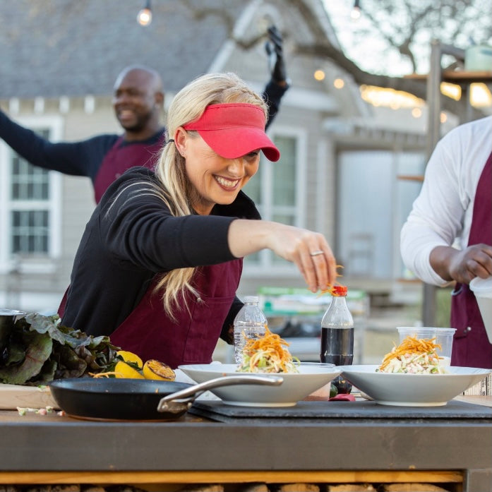 Pitmaster Megan Day finishes "colaslaw"